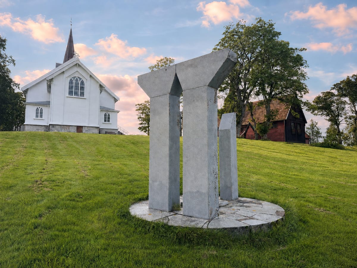 The white church at Kvernes with the stave church behind it