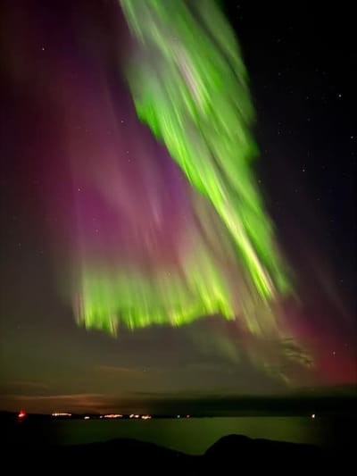 Aurora reflected over open water